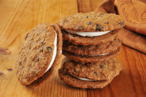 A stack of cream filled oatmeal molasses sandwich cookies